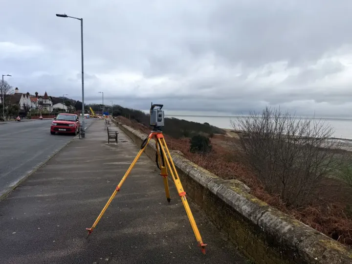 Trimble total station set up on a seafront pavement during a land survey